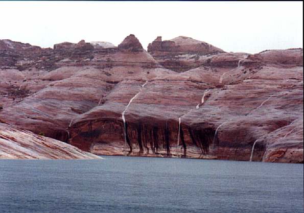 Waterfalls surrounded us pouring down off the cliffs in Escalante River Canyon after the heavy rainfall