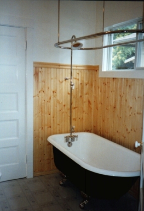 Antique Bath- Cast Iron, Chrome Claw Foot Tub, Chrome Fill Spout and Fixture, Chrome and Porcelain Sunflower Shower Head, Ceiling Hung Chrome Shower Rod, Beaded Knotty Pine Wainscot