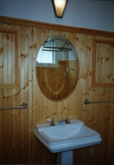 Click on me for a closeup of this view of an Antique Bath- Pedestal Sink, Oval Bevel Mirror, Built-in Medicine Cabinets, Wall Sconce, Beaded Knotty Pine Wainscot